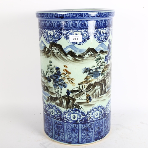 241 - A reproduction Oriental umbrella stand, with blue and white decoration, countryside scene, height 46... 