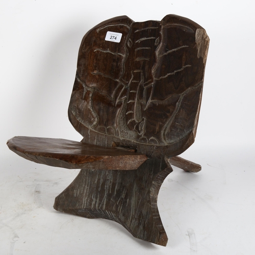 274 - A carved African wood 2-section chair, with the frontal view of an elephant carved into the back of ... 