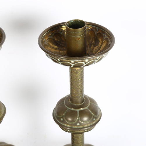 302 - A pair of Gothic brass candlesticks, height 26cm