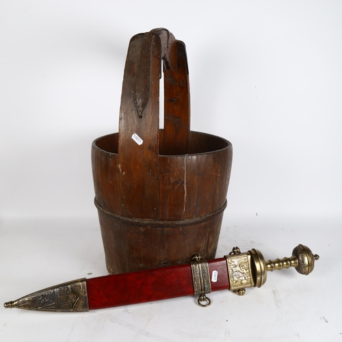 312 - An Antique stave wood and banded iron piggen well bucket, and a replica sword of Julius Caesar 1st c... 