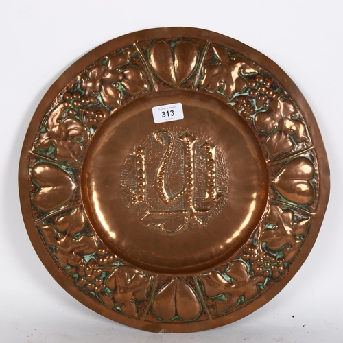 313 - A Gothic Art Nouveau copper church alms plate, relief embossed heart and grapevine surround, diamete... 