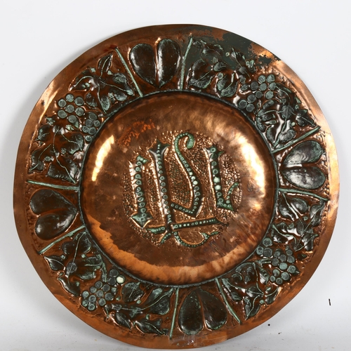 313 - A Gothic Art Nouveau copper church alms plate, relief embossed heart and grapevine surround, diamete... 