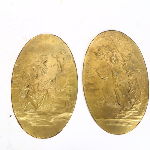 318 - A pair of oval bronzed plaques, with relief decoration, with LG monogram, length 28cm