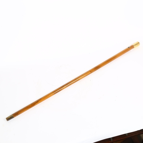 33 - A 19th century Malacca walking cane, with unmarked yellow metal knop, engraved with rampant lion emb... 