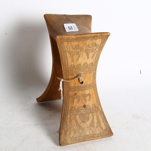 330 - An African wood neck rest with engraved sides, height 19cm