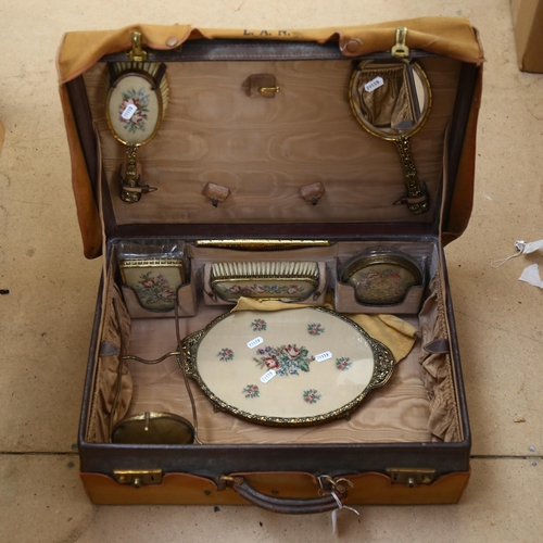 449 - An early 20th century lady's leather vanity case, with fitted interior complete with dressing table ... 