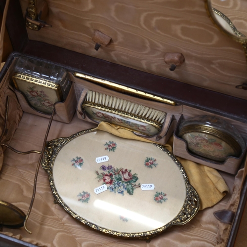 449 - An early 20th century lady's leather vanity case, with fitted interior complete with dressing table ... 