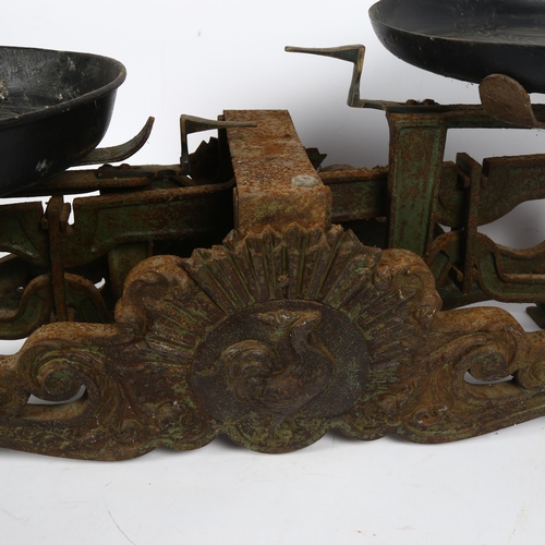 63 - An Antique set of cast-iron balance scales, with relief cockerel motif, width 62cm