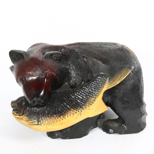 81 - A large Eastern carved and painted bear with fish sculpture, length 40cm, height 24cm