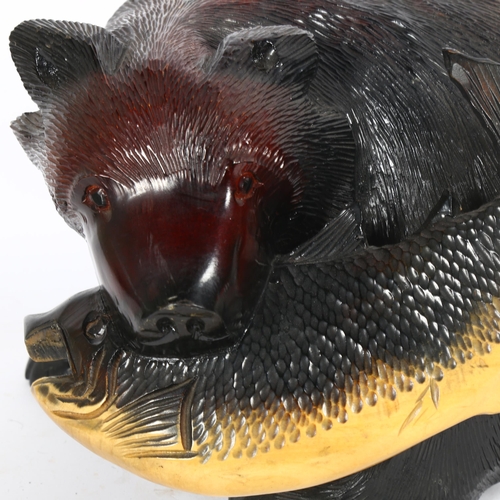81 - A large Eastern carved and painted bear with fish sculpture, length 40cm, height 24cm