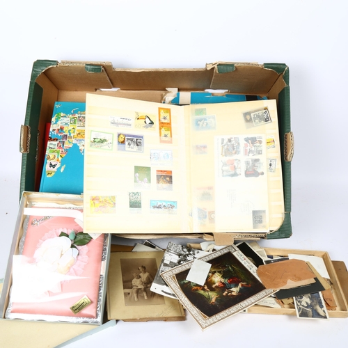 97 - A quantity of postage stamp stock books, cigarette cards, family photographs etc (2 boxes)