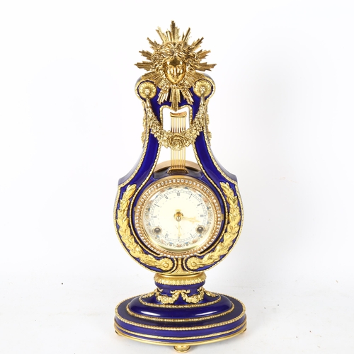 558 - A replica Marie-Antoinette clock from the Victoria & Albert museum, gilded blue glaze porcelain in l... 