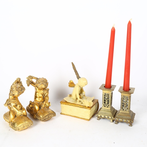 560 - Brass candlesticks, pair of gilded cherubs, and a cherub box