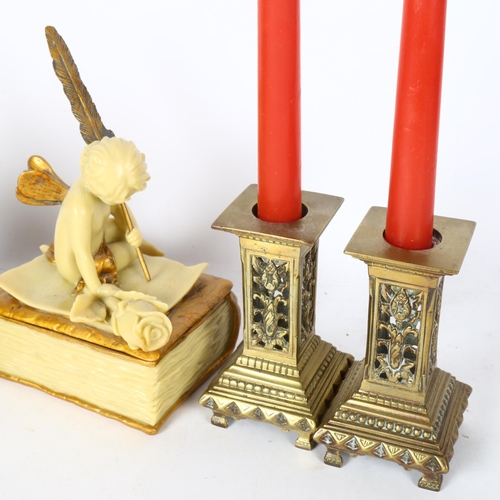 560 - Brass candlesticks, pair of gilded cherubs, and a cherub box