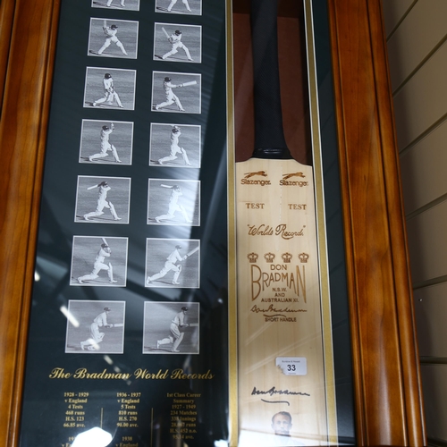 711 - A limited edition Sir Donald Bradman cricket bat, signed with hand painted portrait by Dave Thomas, ... 