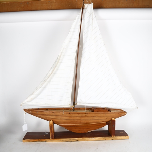 714 - A scratch-built model sailing boat on stand, height overall 1m