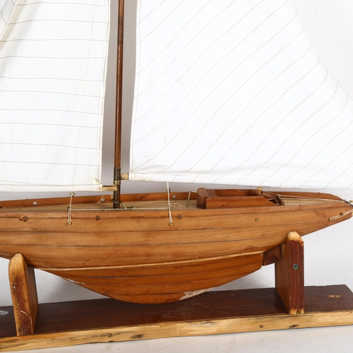 714 - A scratch-built model sailing boat on stand, height overall 1m