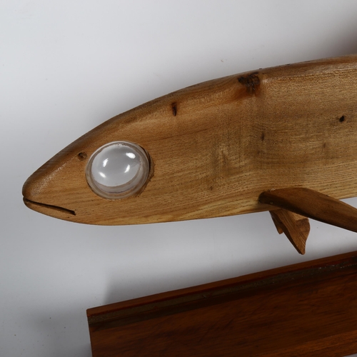 717 - Clive Fredriksson, a carved wood fish with glass eye, length 84cm, on stand