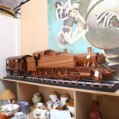 718 - A large scratch-built wooden steam engine and carriage, and 2 sections of track, steam engine length... 