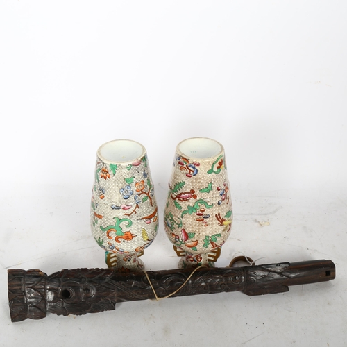 730 - An Oriental carved hardwood flute with mask designs, length 35cm, pair of Oriental vases and a teddy... 