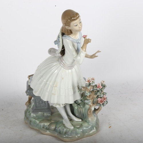 566 - Lladro sculpture of a young girl with flowers, on plinth, 29cm