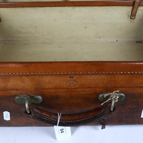 84 - A Vintage leather-covered suitcase, by Army & Navy Cooperative Society Ltd, width 66cm