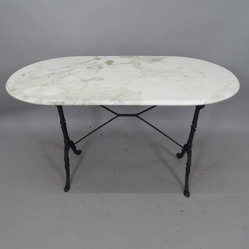 2112 - An oval marble-top garden table, on cast-iron base, 120cm x 70cm x 65cm