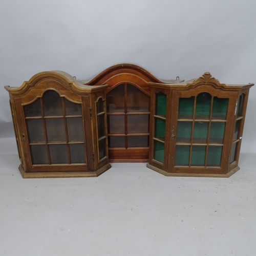 2122 - A mahogany arch-top wall-hanging display cabinet of canted form, 88cm x 74cm x 23cm, and a pair of o... 