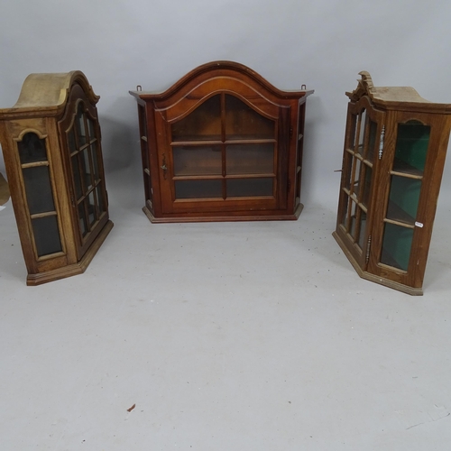 2122 - A mahogany arch-top wall-hanging display cabinet of canted form, 88cm x 74cm x 23cm, and a pair of o... 