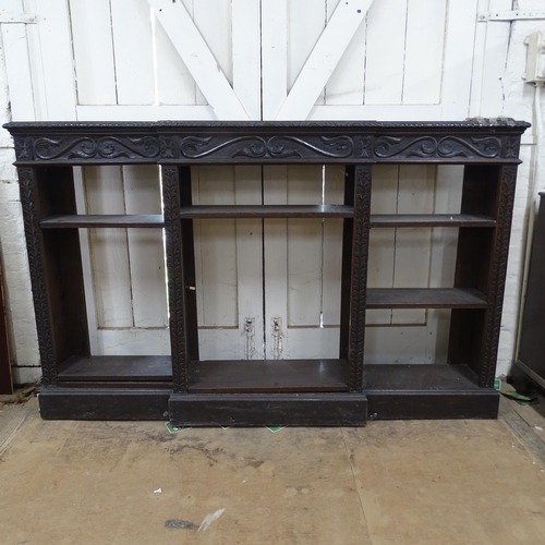 2125 - A Victorian stained oak inverted break-front bookcase, with 6 adjustable shelves and carved decorati... 