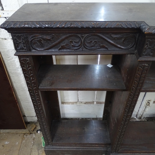 2125 - A Victorian stained oak inverted break-front bookcase, with 6 adjustable shelves and carved decorati... 