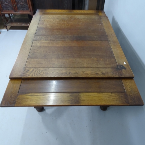 2133 - An early 20th century oak draw leaf dining table, 122cm (extending to 214cm) x 74cm x 107cm