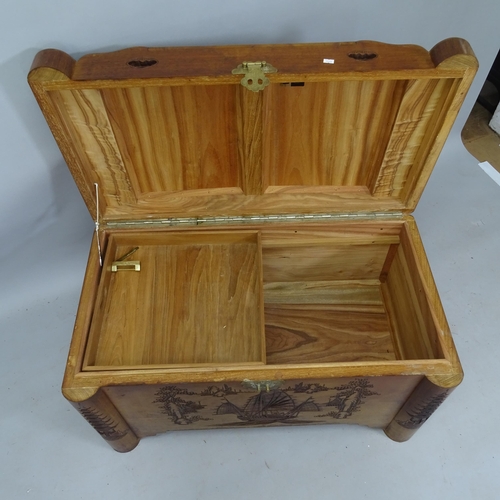 2143 - An Oriental camphorwood blanket chest, with relief carved decoration, 92cm x 56cm x 50cm