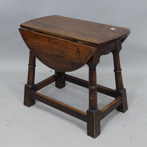 2145 - A small oak oval drop leaf table, 49cm x 45cm x 32cm