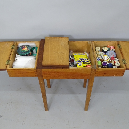 2170 - An early 20th century oak sewing table, having 3 compartments with lifting lids, 71cm x 58cm x 26cm