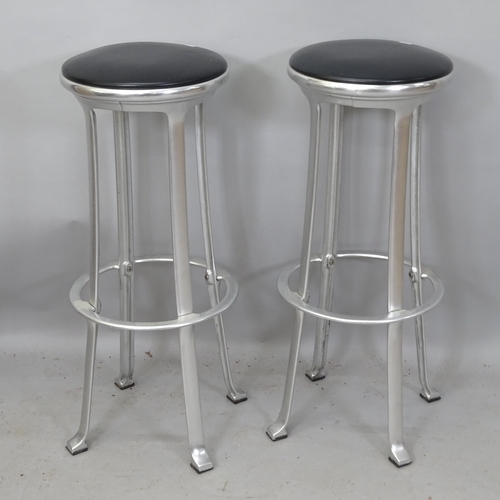 2173 - A pair of mid-century industrial design bar stools, with black leather upholstery, on brushed steel ... 