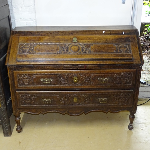 2175 - An Antique oak bureau, the fall-front revealing a fitted interior, with 2 long drawers under, on tur... 