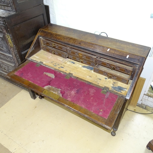 2175 - An Antique oak bureau, the fall-front revealing a fitted interior, with 2 long drawers under, on tur... 