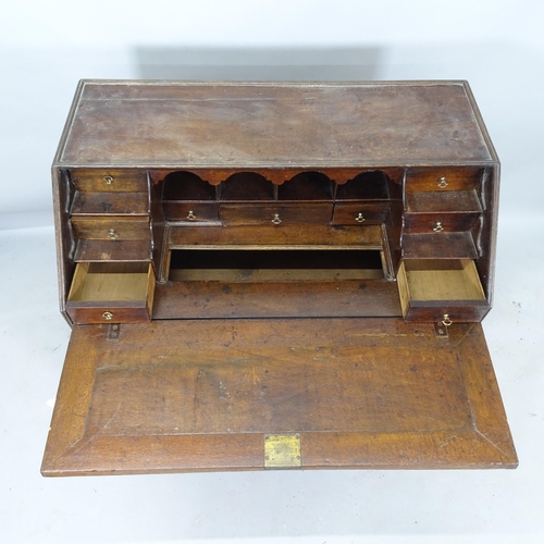 2182 - A Georgian oak bureau, with well fitted interior, and 2 short and 2 long drawers, on bracket feet, 9... 