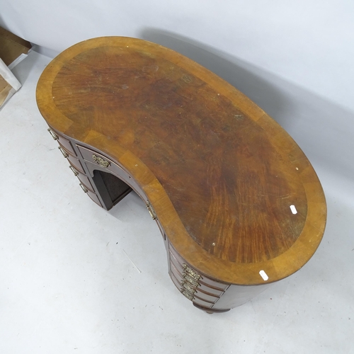 2184 - An Edwardian cross-banded mahogany kidney-shaped writing desk, with 9 fitted drawers and cupboard un... 