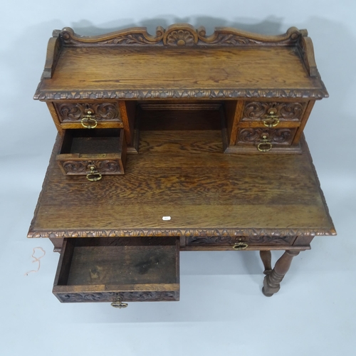 2008 - A Victorian carved oak writing table, with raised back and 6 fitted drawers, with H-shaped stretcher... 