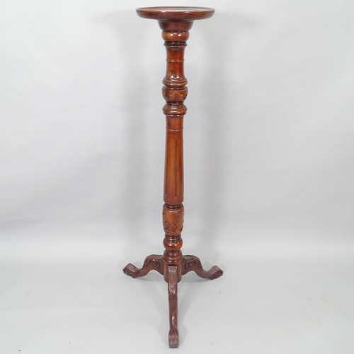 2011 - An Antique mahogany torcher, with carved and fluted decoration, on tripod base, H134cm