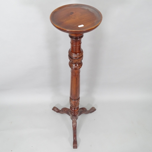 2011 - An Antique mahogany torcher, with carved and fluted decoration, on tripod base, H134cm