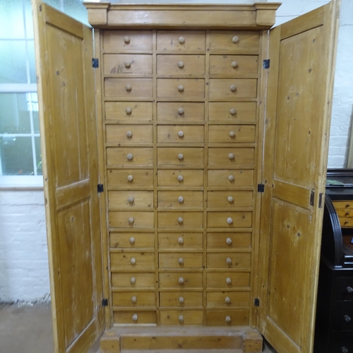 2039 - An Antique pine 2-door shop cabinet, with 42 fitted drawers, and carved fluted decoration, 118cm x 2... 