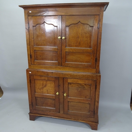 2040 - An 18th Century oak 4-door house maids cupboard, with shelf-fitted interior, on bracket feet, 112cm ... 