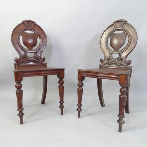 2057 - A pair of Victorian mahogany shield-back hall chairs