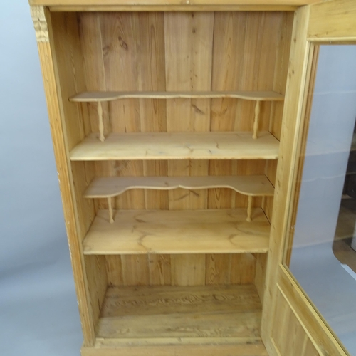 2066 - A pine display cabinet, with single glazed door and applied carved decoration, 111cm x 175cm x 57cm