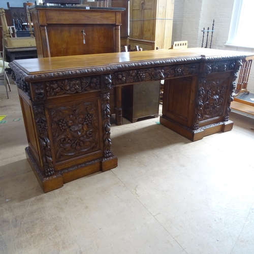 2067 - A Victorian oak pedestal sideboard, by Edwards & Roberts, with carved lion and foliate decoration, h... 