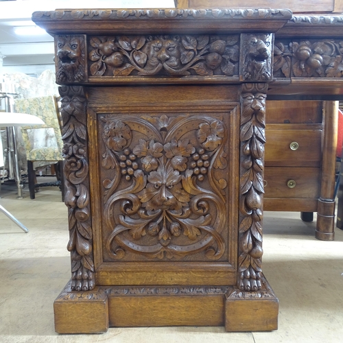 2067 - A Victorian oak pedestal sideboard, by Edwards & Roberts, with carved lion and foliate decoration, h... 