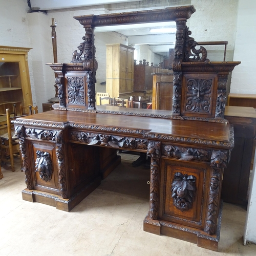 2068 - A Victorian carved oak pedestal sideboard, with raised mirrored back, allover carved decoration, 3 f... 